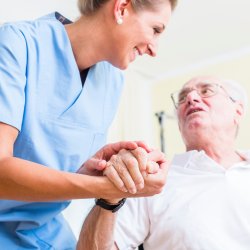 16280732-nurse-holding-hand-of-senior-man-in-rest-home